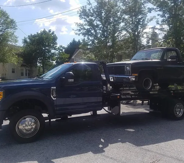 Truck being towed for emergency roadside assistance.